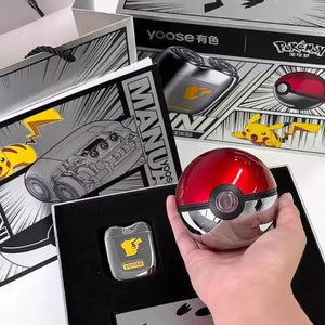 Hand holding Pokéball travel case with Pikachu electric shaver gift box background