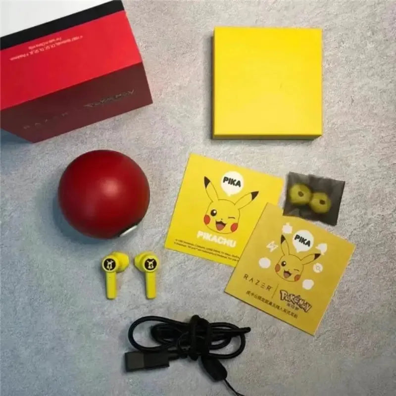Pikachu Poké Ball earbuds with box and charging accessories